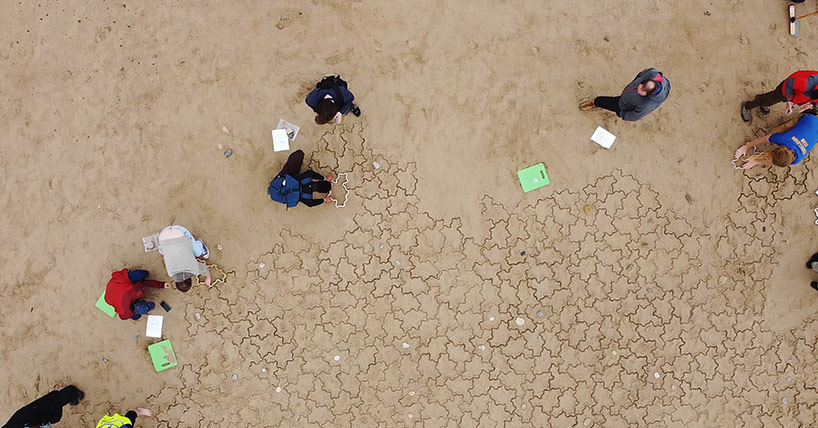 Members of the public joined mathematicians from Newcastle University to create what organisers believe is the largest aperiodic tiling ever attempted on Whitley Bay beach.